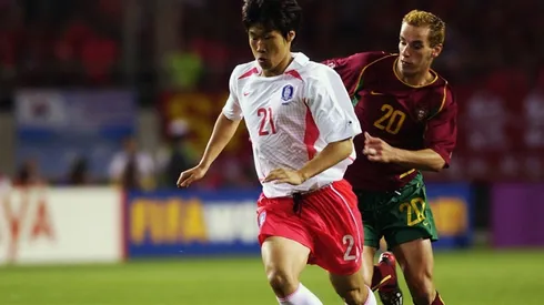 Ji Sung Park of South Korea holds off Petit of Portugal