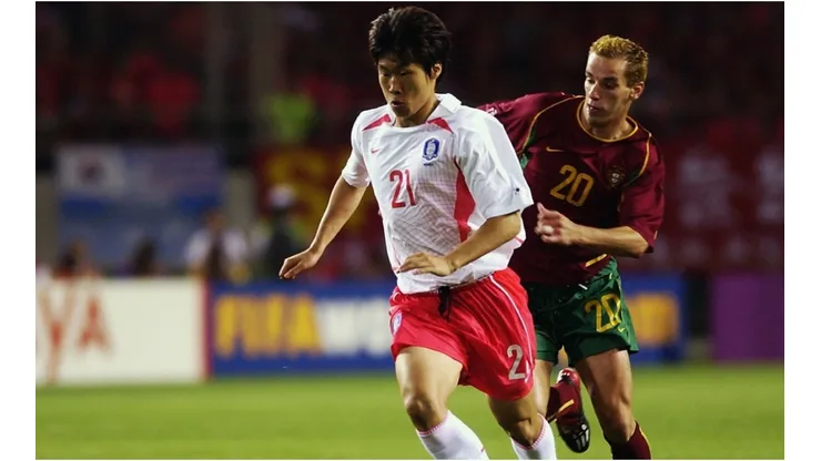 Ji Sung Park of South Korea holds off Petit of Portugal