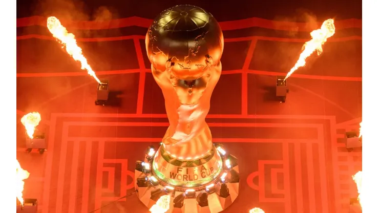 Pyrotechnics explode around a giant FIFA World Cup Trophy