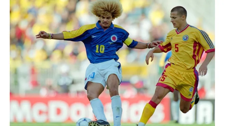 Colombia captain Carlos Valderrama (l) holds off the challenge of Constantin Galca of Romania during the 1998 FIFA World Cup Group match between Colombia and Romania on June 15, 1998 in Lyon, France.