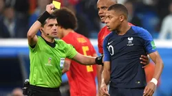 Mbappe receiving a yellow card in Russia 2018.