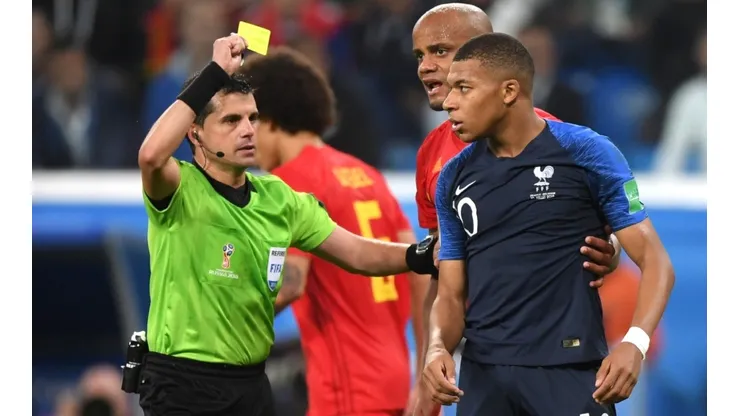 Mbappe receiving a yellow card in Russia 2018.