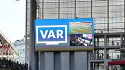 A VAR review displayed on a big screen.