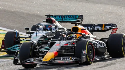George Russell of Mercedes attacks Max Verstappen of Red Bull Racing