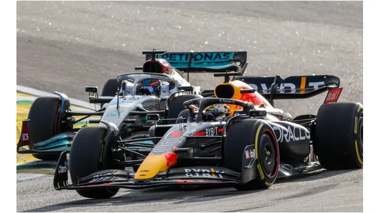 George Russell of Mercedes attacks Max Verstappen of Red Bull Racing