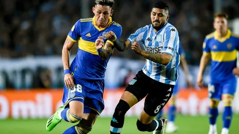 Luis Vazquez of Boca Juniors fights for the ball with Jonathan Galvan of Racing Club