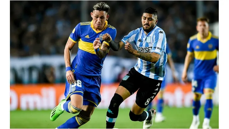 Luis Vazquez of Boca Juniors fights for the ball with Jonathan Galvan of Racing Club