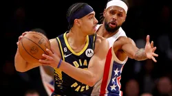 Andrew Nembhard of the Indiana Pacers tries to keep the ball from Patty Mills of the Brooklyn Nets