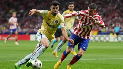 Mehdi Taremi of FC Porto turns with the ball under pressure from Jose Gimenez of Atletico de Madrid
