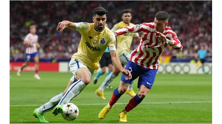 Mehdi Taremi of FC Porto turns with the ball under pressure from Jose Gimenez of Atletico de Madrid