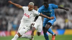 Richarlison of Tottenham Hotspur battles for possession with Eric Bailly of Marseille