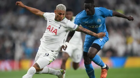 Richarlison of Tottenham Hotspur battles for possession with Eric Bailly of Marseille