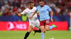 Bernardo Silva of Manchester City is challenged by Joan Jordan of Sevilla FC