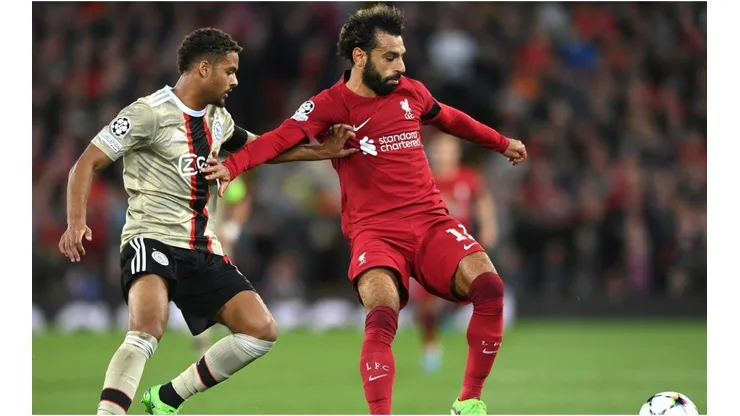 Ajax defender Devyne Rensch (l) challenges Liverpool forward Mohammed Salah