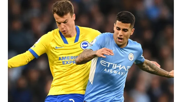 Solly March of Brighton and Joao Cancelo of Manchester City