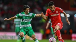 Carlos Orrantia of Santos Laguna fights for the ball with Jorge Rodriguez of Toluca