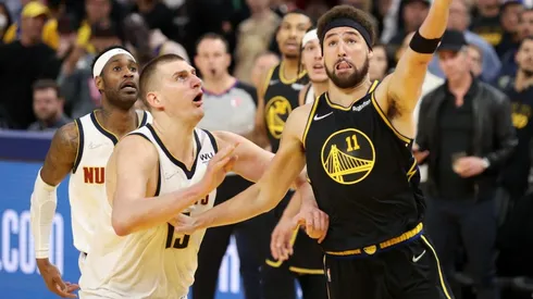 Klay Thompson of the Golden State Warriors shoots over Nikola Jokic of the Denver Nuggets