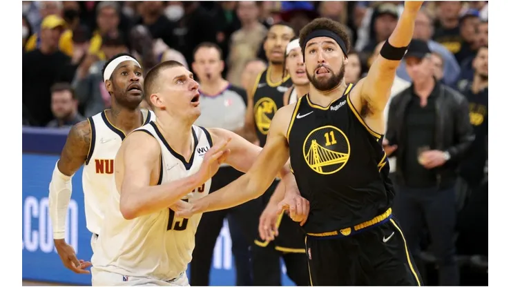Klay Thompson of the Golden State Warriors shoots over Nikola Jokic of the Denver Nuggets