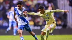 Martin Barragan of Puebla battles for possession with Emilio Lara of America
