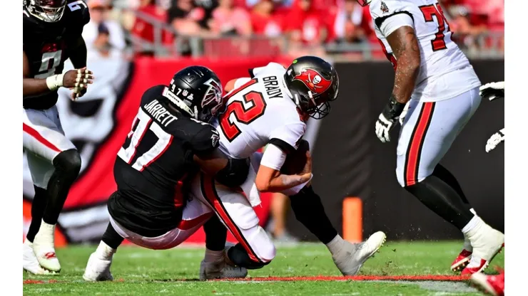 Grady Jarrett (left) taking down Tom Brady in 2022 during a Week 5 game, Bucs vs Falcons