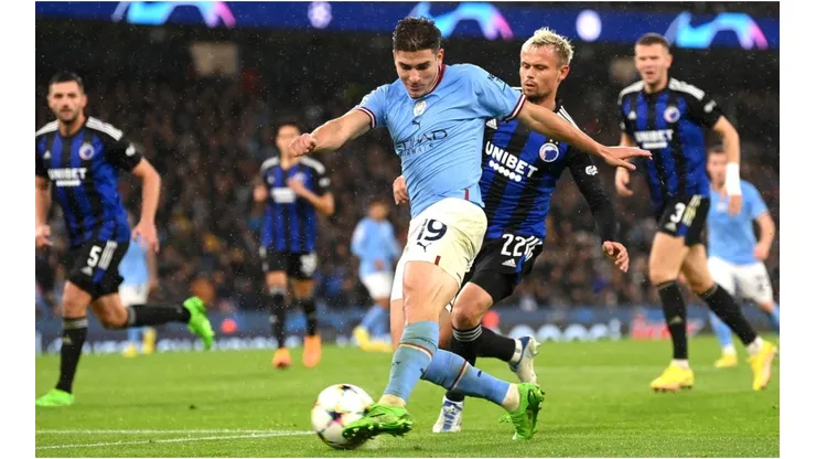 Julian Alvarez of Manchester City shoots under pressure from Peter Ankersen of FC Copenhagen