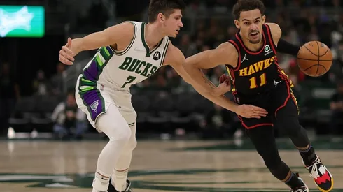 Trae Young of the Atlanta Hawks drives around Grayson Allen of the Milwaukee Bucks