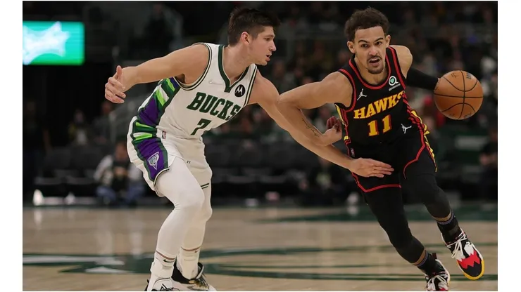 Trae Young of the Atlanta Hawks drives around Grayson Allen of the Milwaukee Bucks