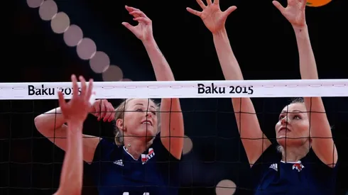 Joanna Wolosz (L) of Poland jumps at the net