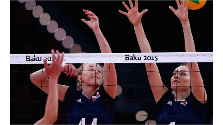 Joanna Wolosz (L) of Poland jumps at the net