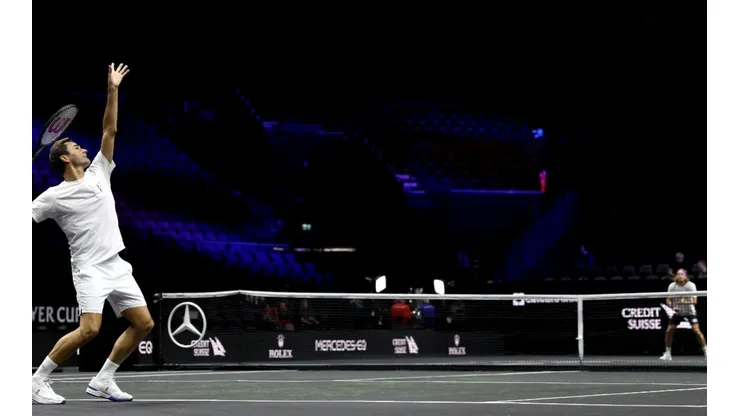 Roger Federer serves during a practice session