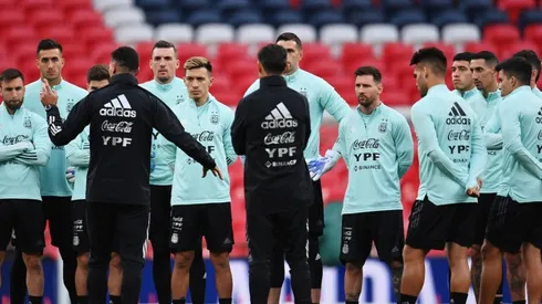 Lionel Messi listens to Lionel Scaloni, Head Coach of Argentina during the Argentina Training Session at Wembley Stadium on May 31, 2022 in London, England.
