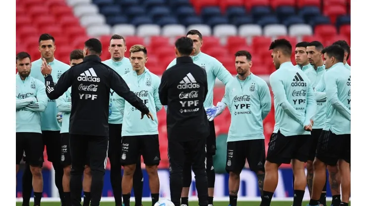 Lionel Messi listens to Lionel Scaloni, Head Coach of Argentina during the Argentina Training Session at Wembley Stadium on May 31, 2022 in London, England.