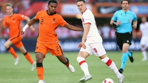 Piotr Zielinski of Poland makes a pass whilst under pressure from Jurrien Timber of Netherlands