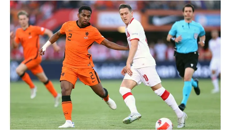 Piotr Zielinski of Poland makes a pass whilst under pressure from Jurrien Timber of Netherlands