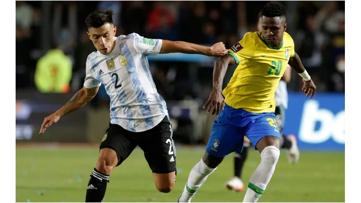 Lisandro Martínez of Argentina competes for the ball with Vinicius Junior of Brazil
