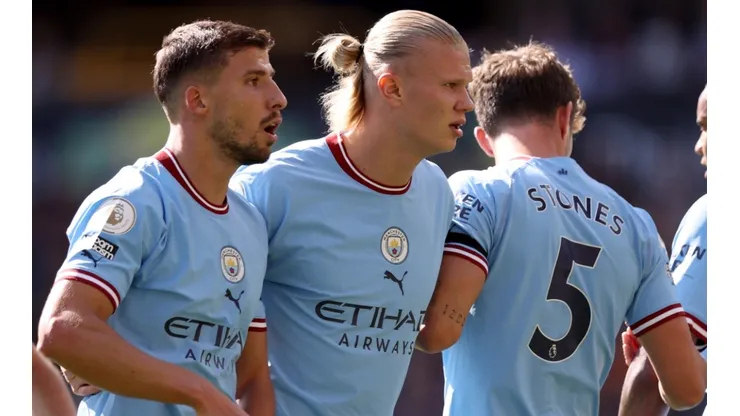 Ruben Dias, Erling Haaland, and John Stones of Manchester City