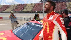 Bubba Wallace celebrates after winning the pole award for the FireKeepers Casino 400
