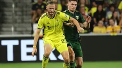 Walker Zimmerman of Nashville SC battles for the ball with Jarosław Niezgoda of Portland Timbers