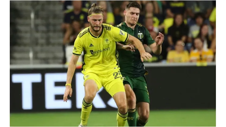 Walker Zimmerman of Nashville SC battles for the ball with Jarosław Niezgoda of Portland Timbers