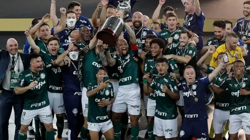 Felipe Melo and Gustavo Gomez of Palmeiras lift the Copa Libertadores trophy