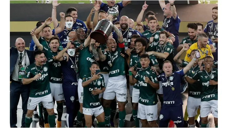 Felipe Melo and Gustavo Gomez of Palmeiras lift the Copa Libertadores trophy