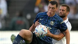 Federico Vinas and Nacho fighting for a ball during their 2022 friendly match.