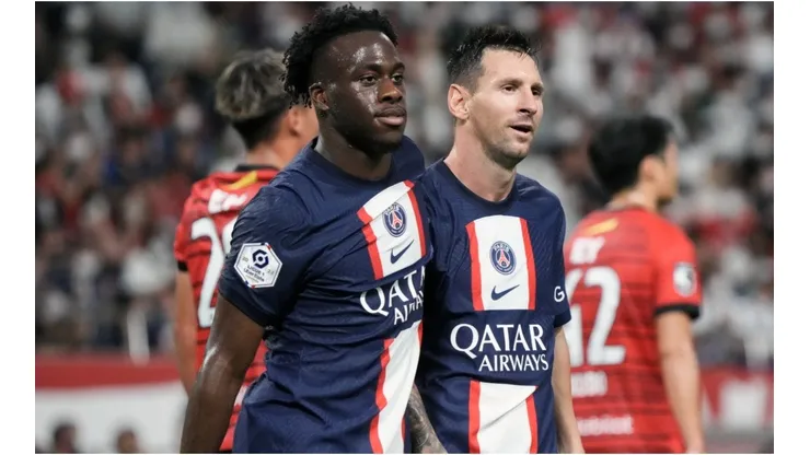 Arnaud Kalimuendo (L) of Paris Saint-Germain celebrates with Lionel Messi (R)