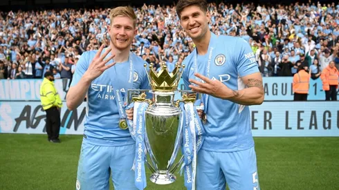 Kevin De Bruyne and John Stones of Manchester City celebrate with the Premier League trophy