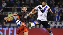 Braian Romero of River Plate (left) against Matias de los Santos of Velez.