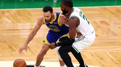 Stephen Curry of the Golden State Warriors is defended by Jaylen Brown of the Boston Celtics