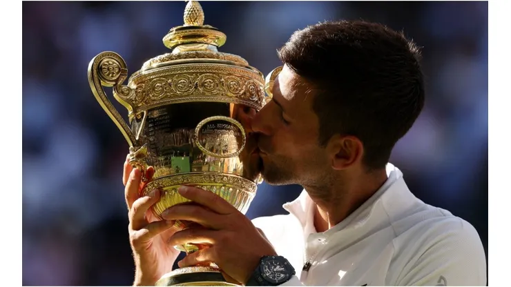 Novak Djokovic of Serbia kisses the Wimbledon trophy