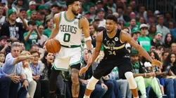 Jayson Tatum of the Boston Celtics handles the ball against Giannis Antetokounmpo of the Milwaukee Bucks