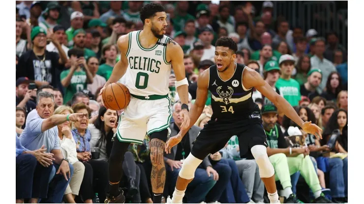 Jayson Tatum of the Boston Celtics handles the ball against Giannis Antetokounmpo of the Milwaukee Bucks