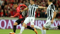 Vitor Hugo of Athletico Paranaense fights for the ball with Alvaro Marcial Campuzano of Libertad